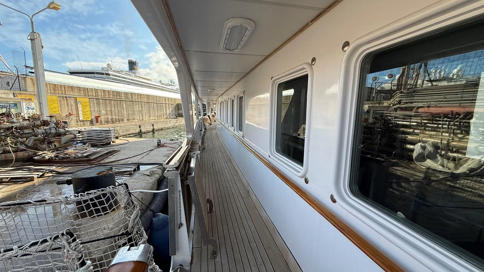 The side deck of the yacht offers a spacious walkway with a view of the marina. aboard LADY SARYA Yacht for Sale