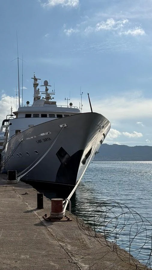 A majestic yacht is docked at the pier under a clear blue sky. aboard LADY SARYA Yacht for Sale