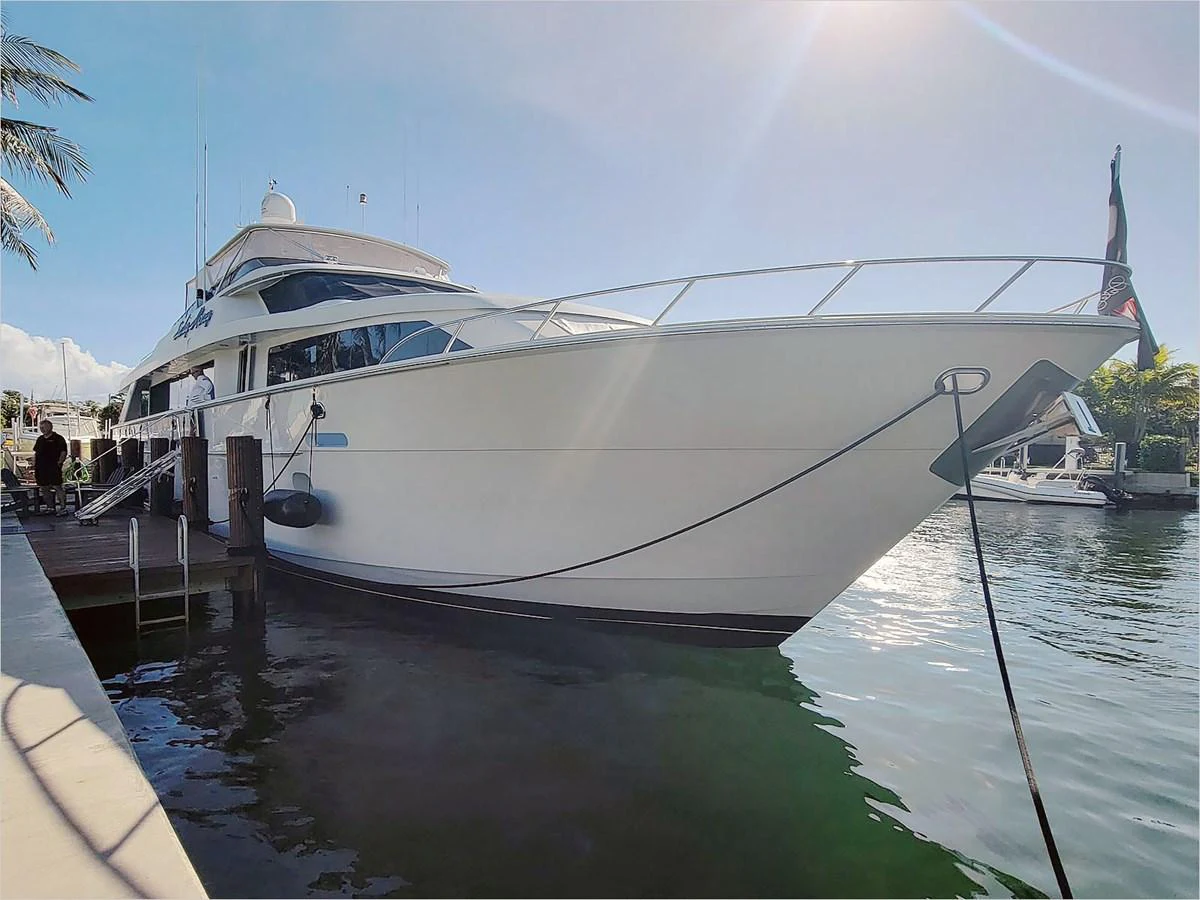 a large white boat docked at a pier aboard 100' HATTERAS 2001 CUSTOM YACHT Yacht for Sale