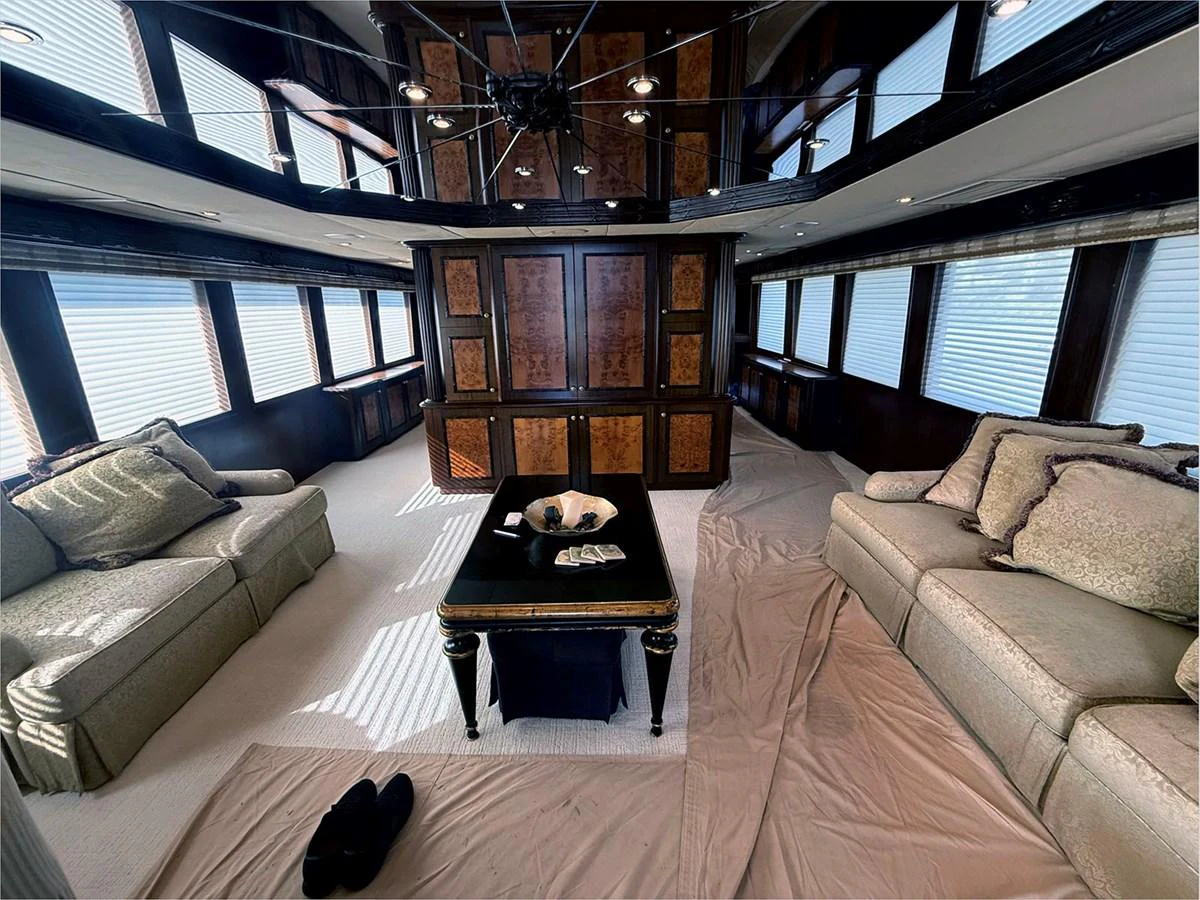 a living room with a couch and a coffee table aboard 100' HATTERAS 2001 CUSTOM YACHT Yacht for Sale