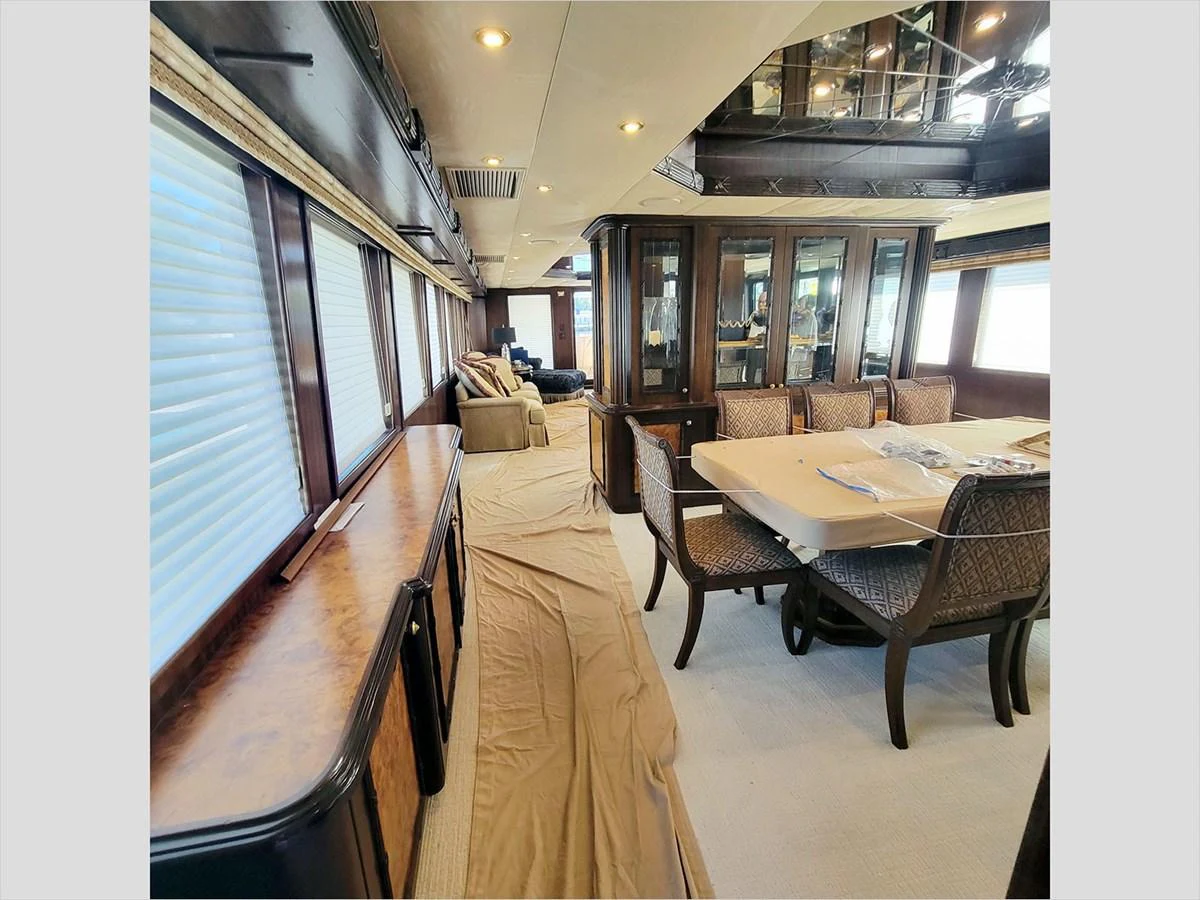 a dining room with a table and chairs aboard 100' HATTERAS 2001 CUSTOM YACHT Yacht for Sale
