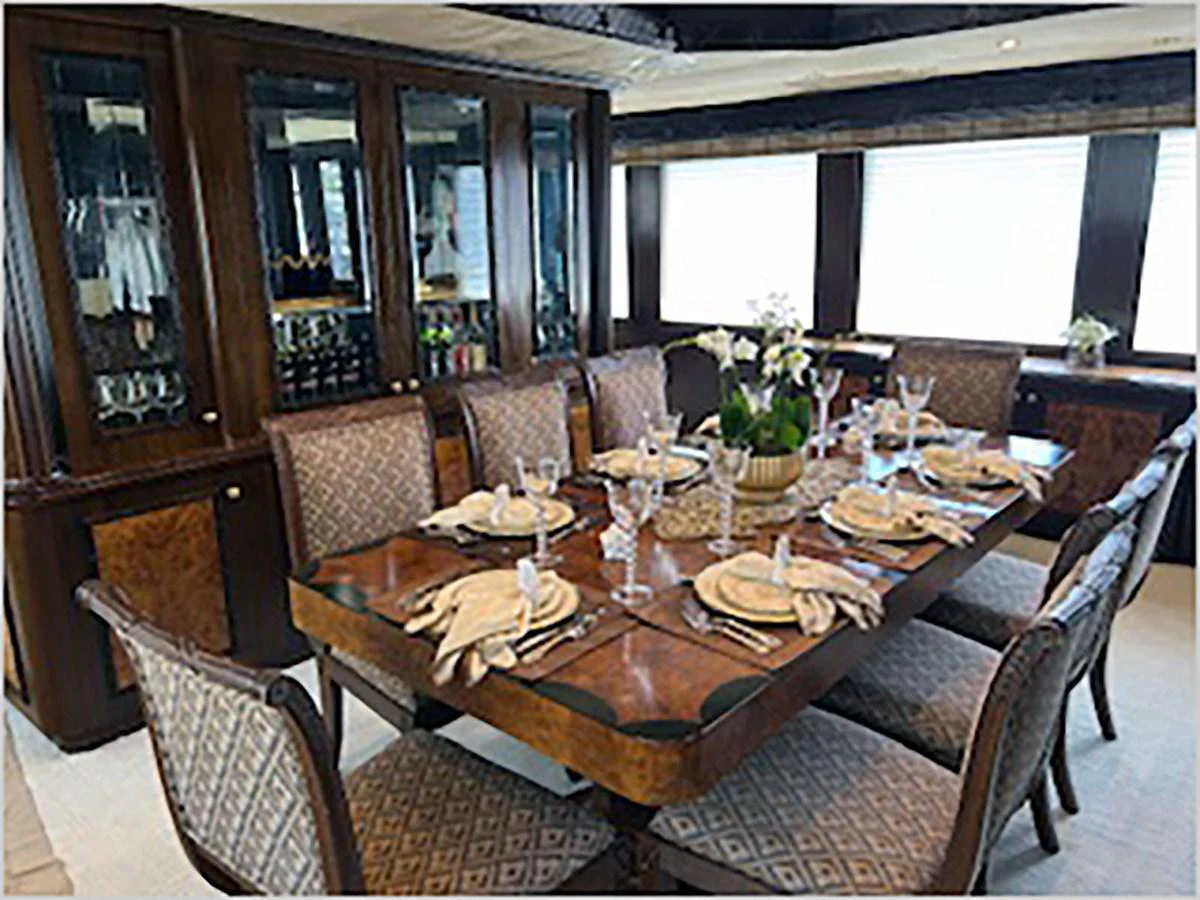 a dining room table set for a meal aboard 100' HATTERAS 2001 CUSTOM YACHT Yacht for Sale