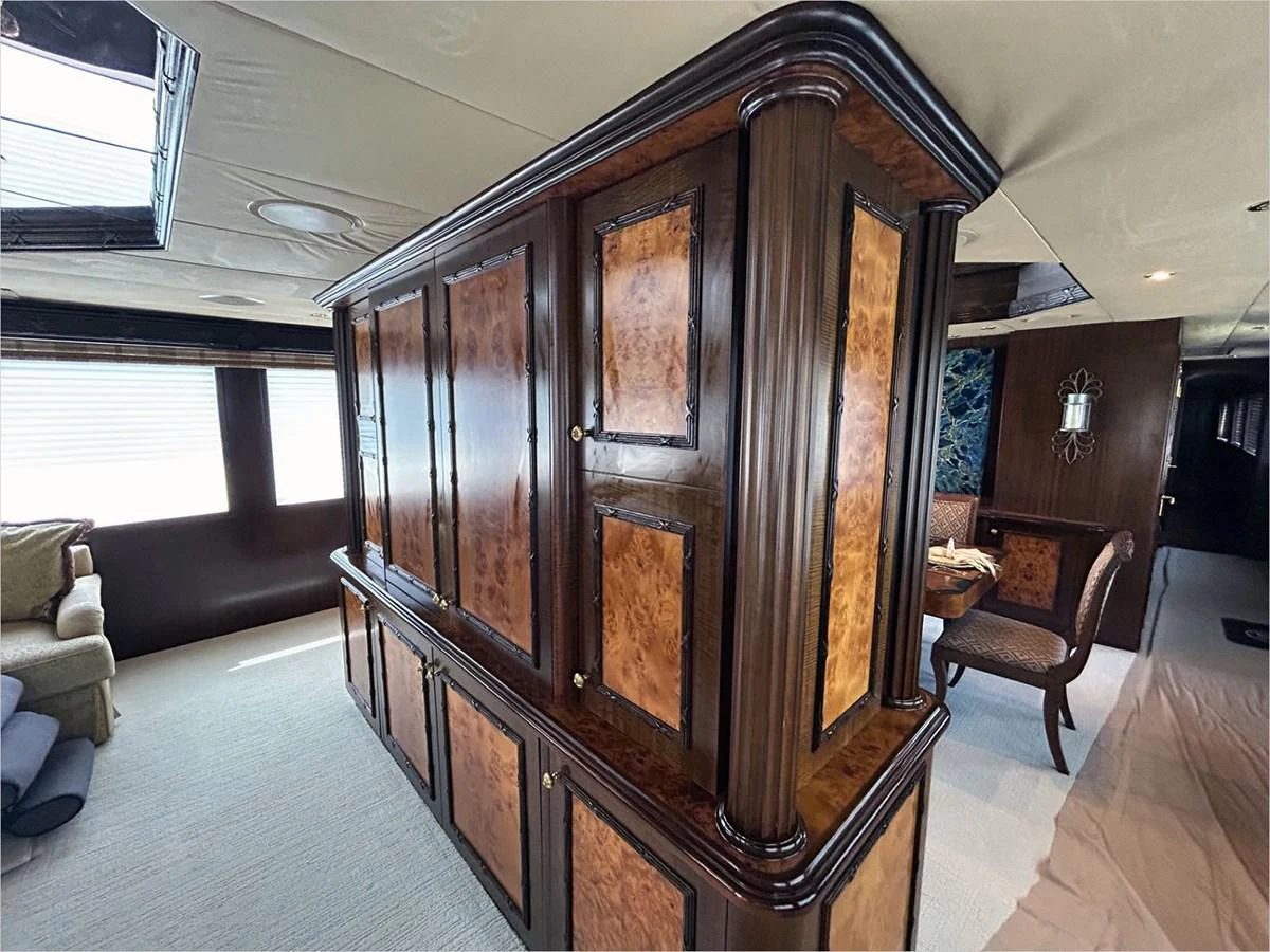 a large wooden cabinet in a room aboard 100' HATTERAS 2001 CUSTOM YACHT Yacht for Sale