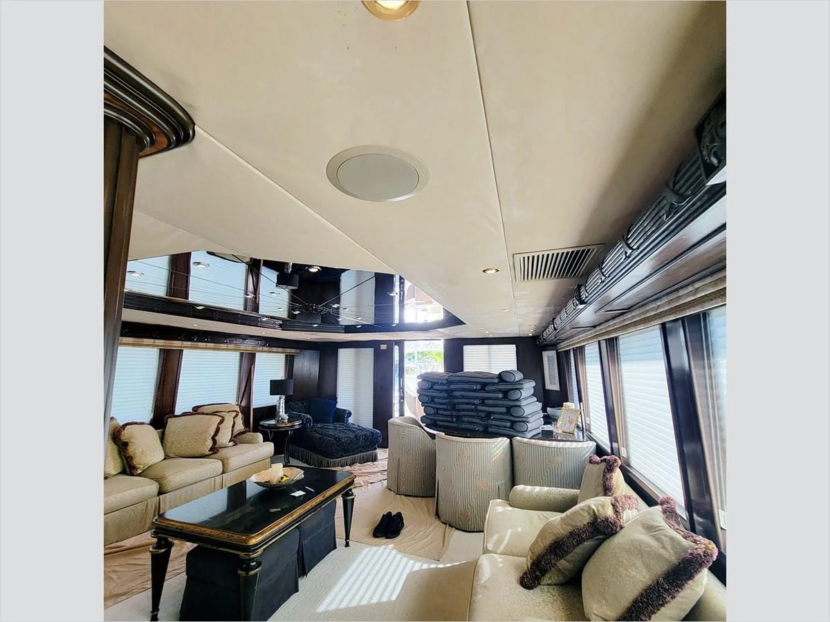 a room with a bed and a desk aboard 100' HATTERAS 2001 CUSTOM YACHT Yacht for Sale