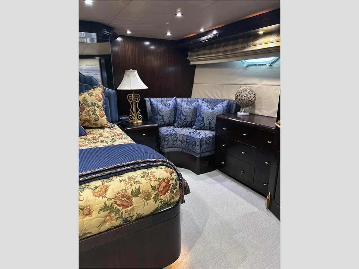 a living room with a blue couch aboard 100' HATTERAS 2001 CUSTOM YACHT Yacht for Sale