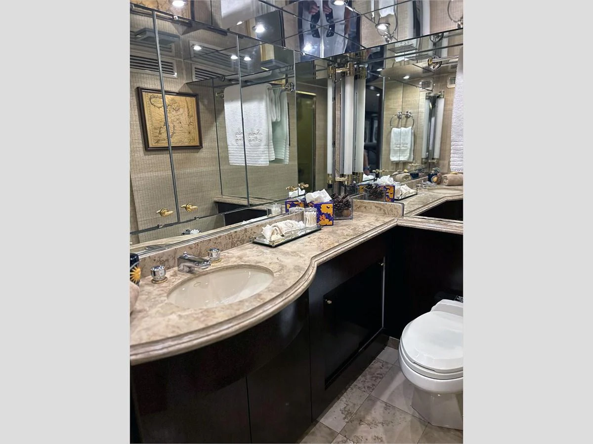 a bathroom with a sink and a toilet aboard 100' HATTERAS 2001 CUSTOM YACHT Yacht for Sale