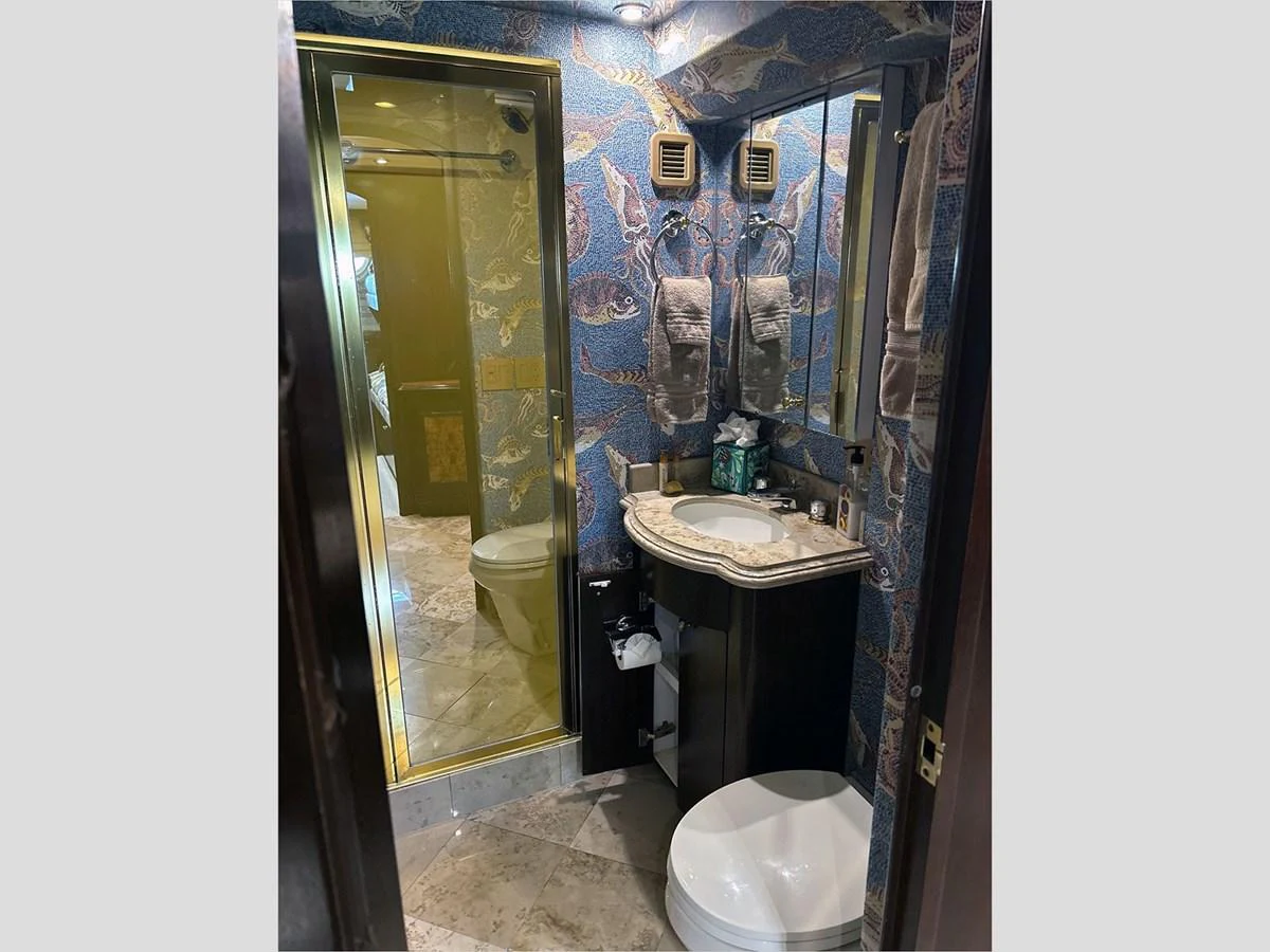 a bathroom with a sink and a toilet aboard 100' HATTERAS 2001 CUSTOM YACHT Yacht for Sale