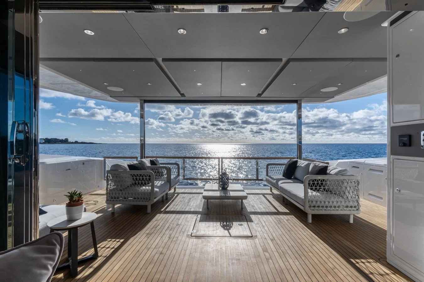 a deck with chairs and a table aboard AURELIUS Yacht for Sale