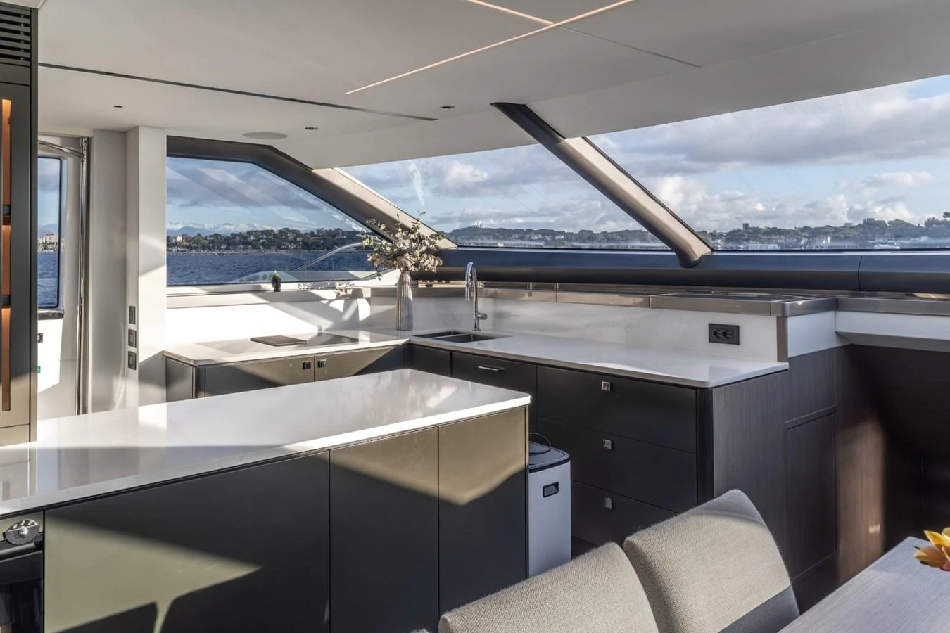 a kitchen with a view of the ocean and mountains aboard AURELIUS Yacht for Sale
