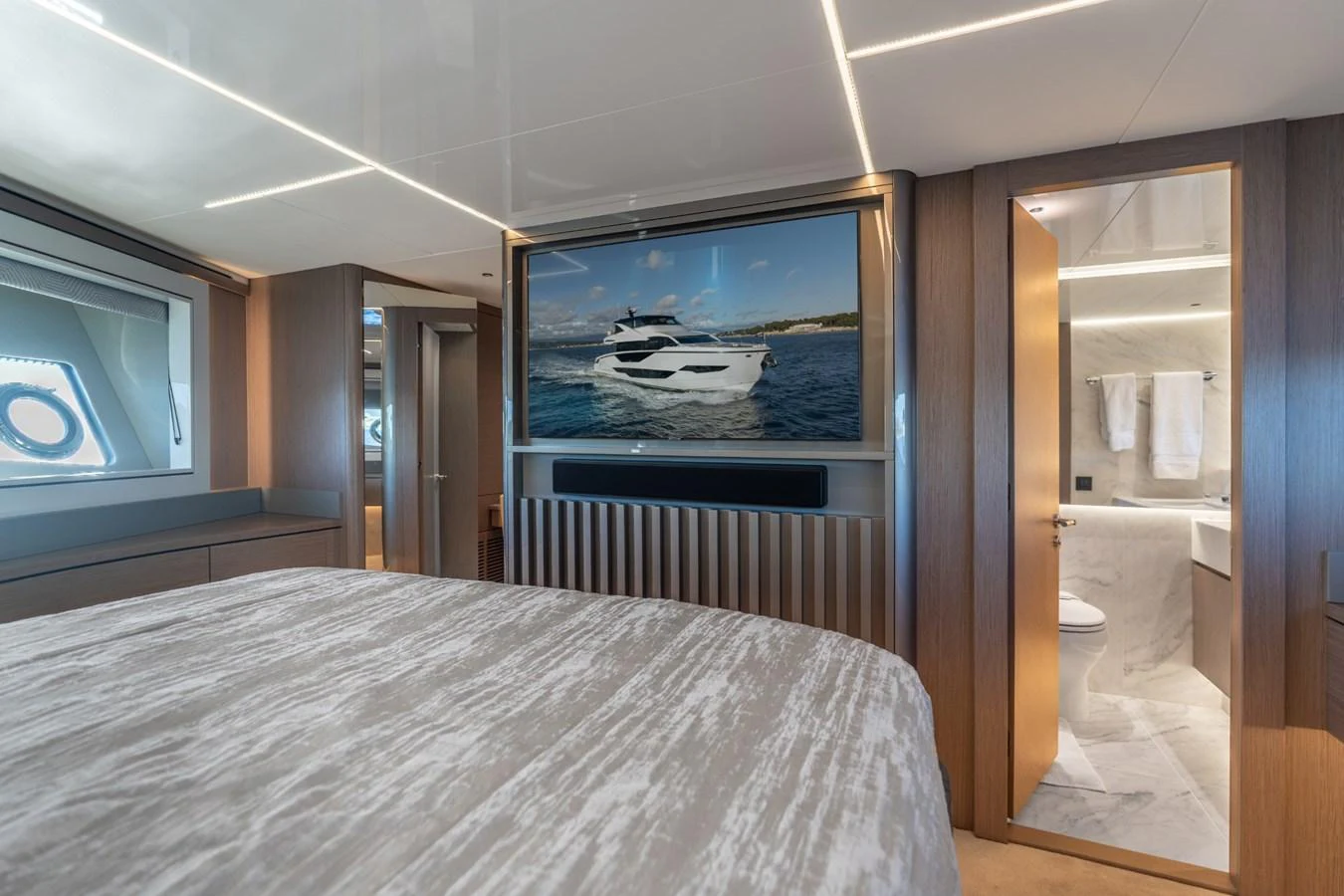 a bedroom with a large television aboard AURELIUS Yacht for Sale