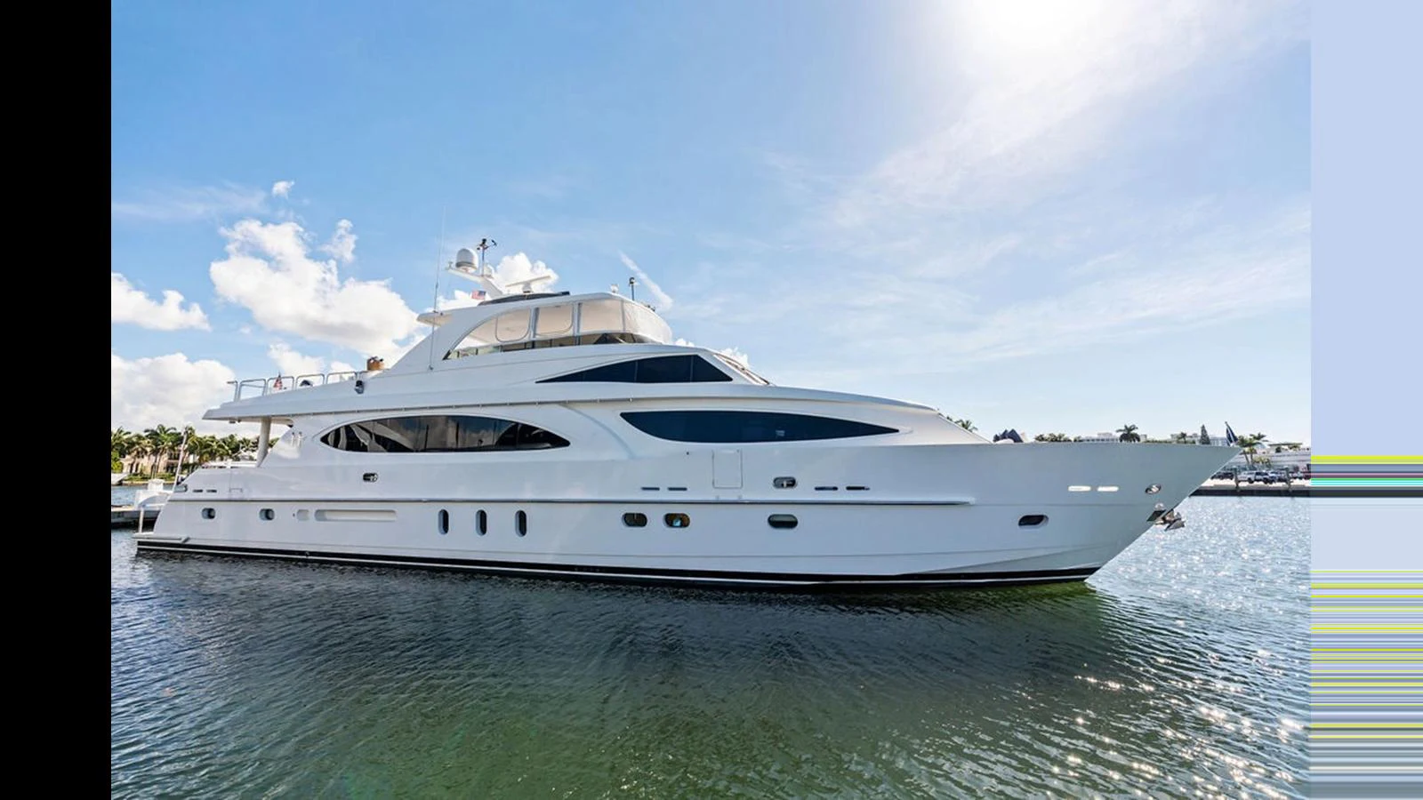 A luxurious yacht is gracefully moored on calm waters under a clear blue sky. aboard PERFECT HARMONY Yacht for Sale