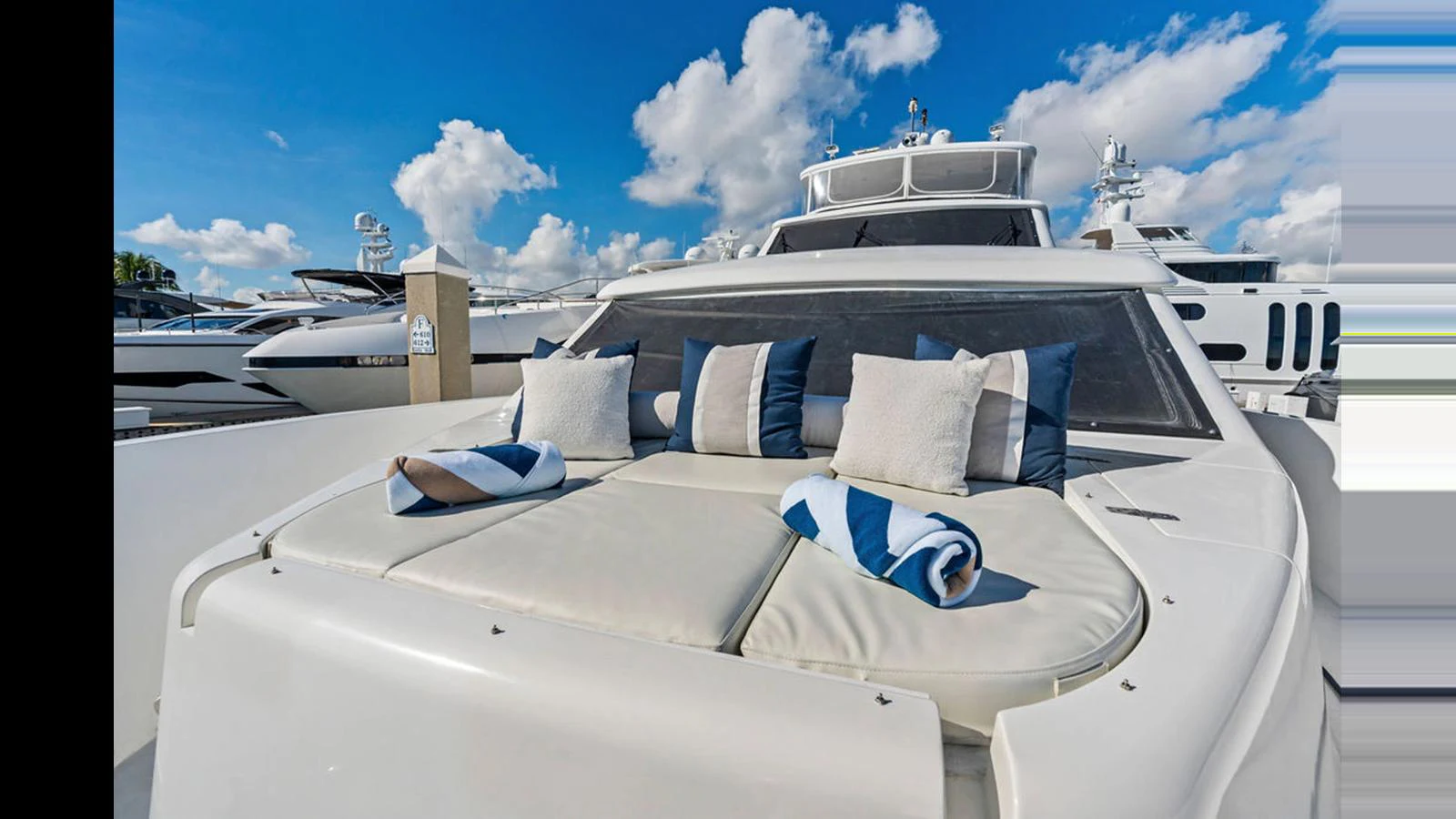 The foredeck of the yacht features a comfortable sunbathing area with plush cushions and rolled towels. aboard PERFECT HARMONY Yacht for Sale