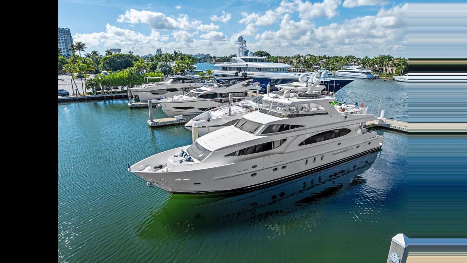 A luxurious yacht is docked at a serene marina, showcasing its sleek design and spacious decks. aboard PERFECT HARMONY Yacht for Sale