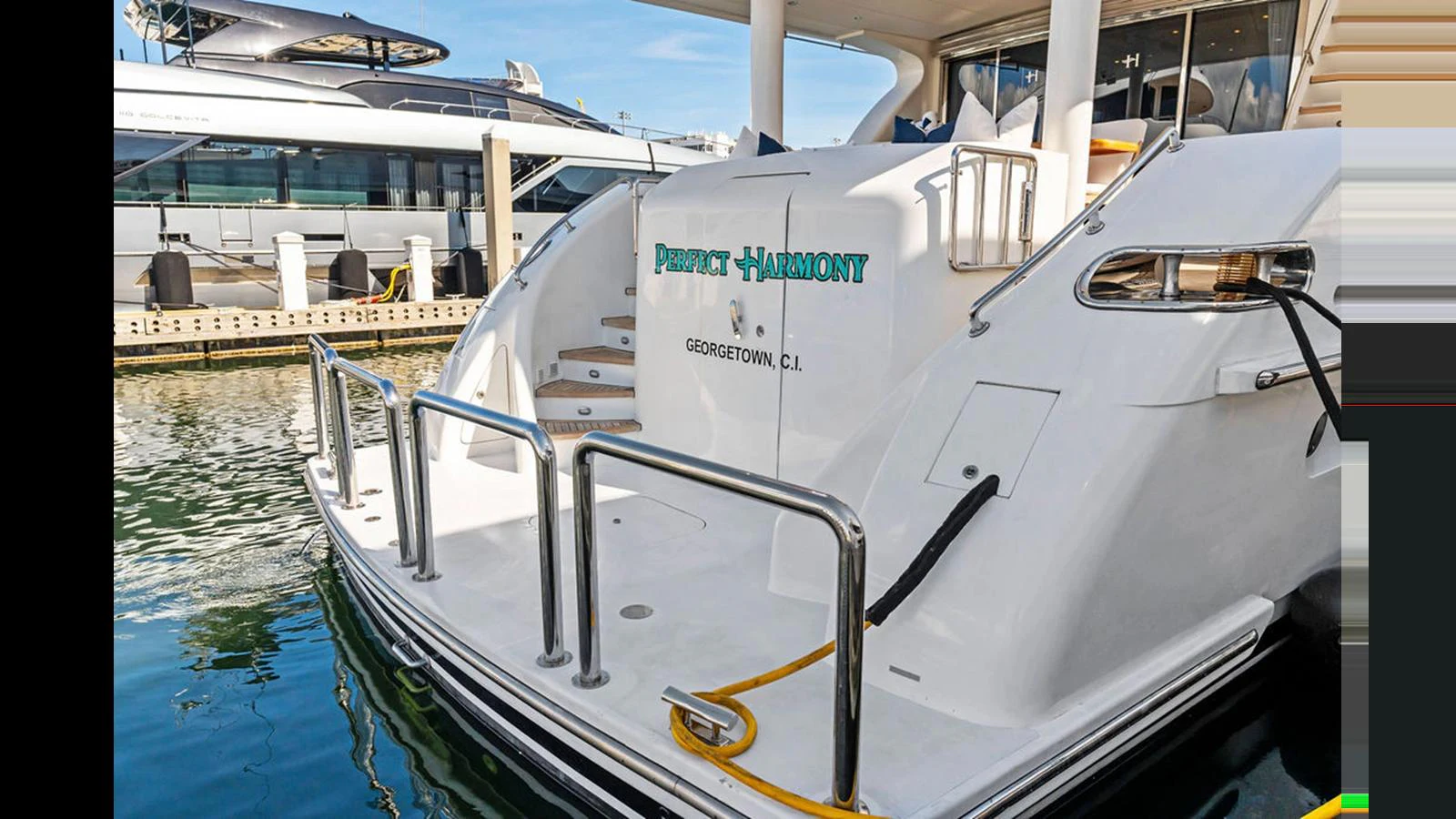 The yacht's aft deck features a spacious swim platform with easy access to the water. aboard PERFECT HARMONY Yacht for Sale