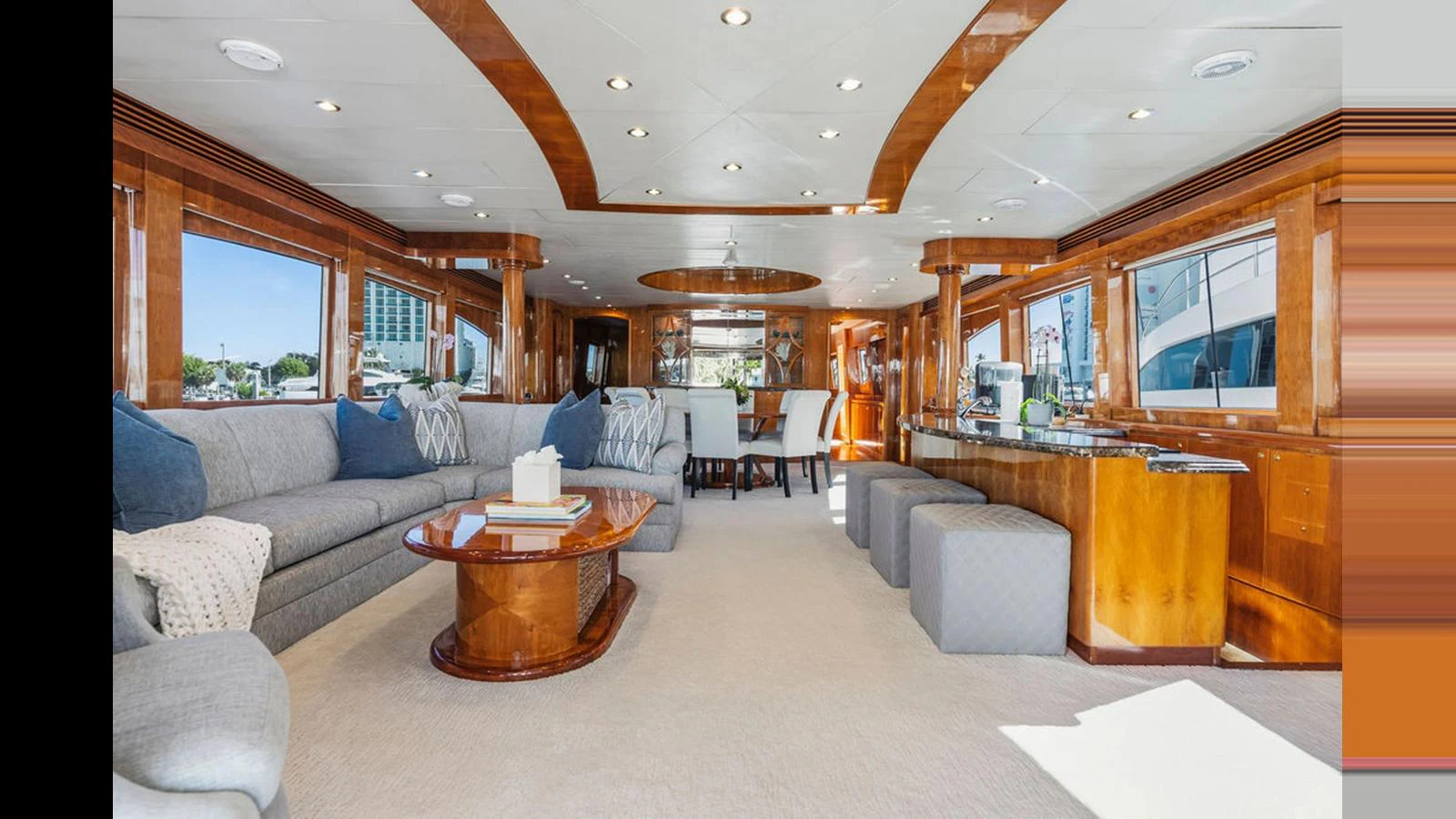 The salon features luxurious seating and elegant wooden accents, creating a warm and inviting atmosphere. aboard PERFECT HARMONY Yacht for Sale