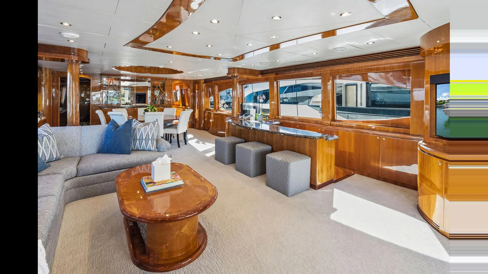 The spacious salon features elegant wood finishes, plush seating, and ample natural light. aboard PERFECT HARMONY Yacht for Sale