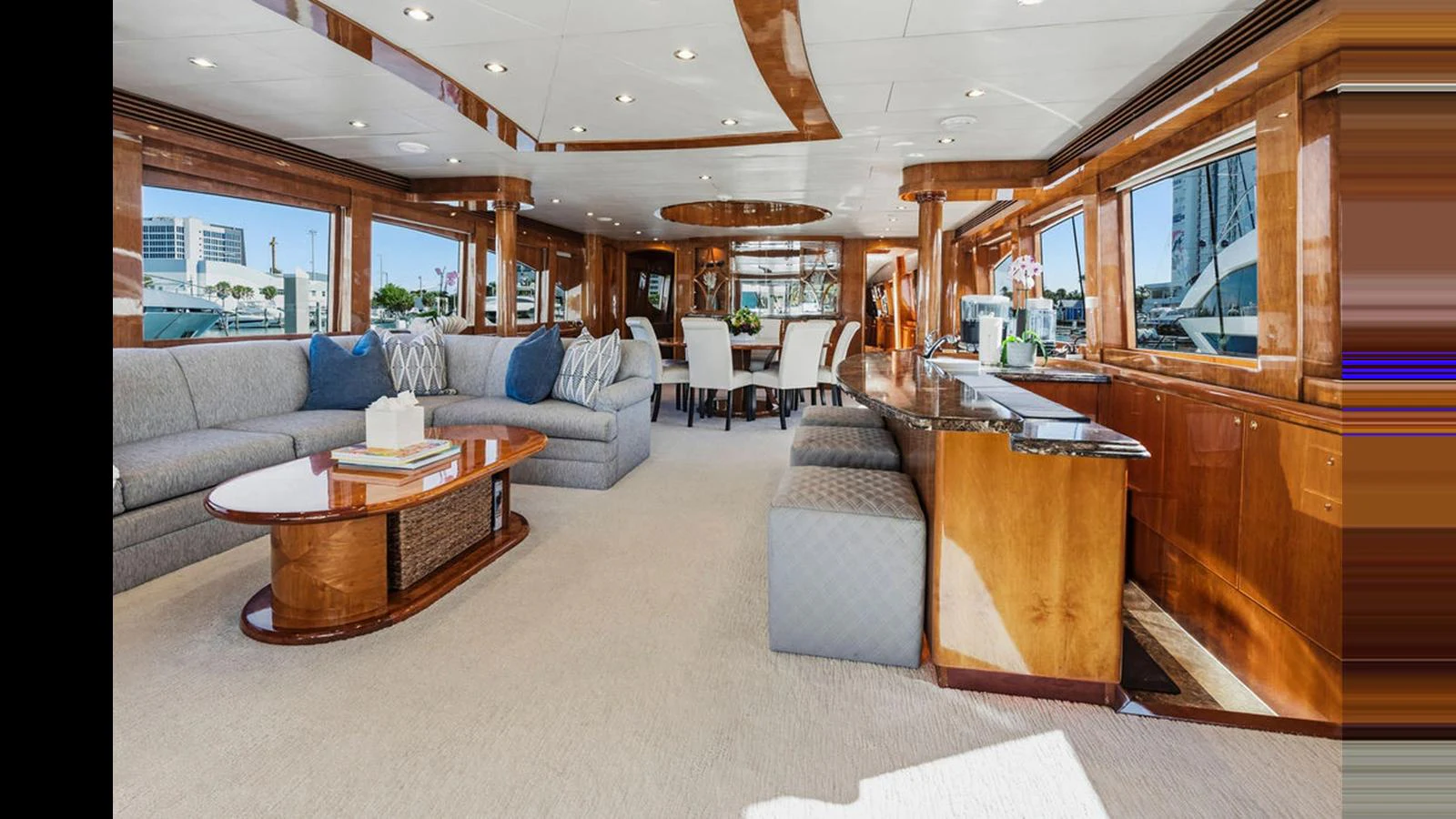 The spacious salon features elegant seating and a dining area with ample natural light. aboard PERFECT HARMONY Yacht for Sale