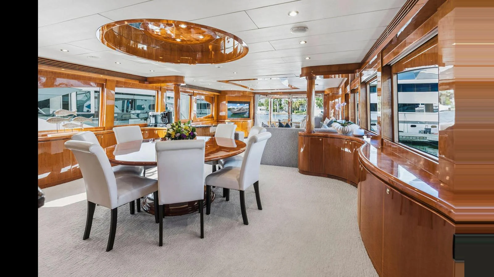 The yacht's dining area features elegant wooden finishes and plush seating, creating a sophisticated and inviting atmosphere. aboard PERFECT HARMONY Yacht for Sale