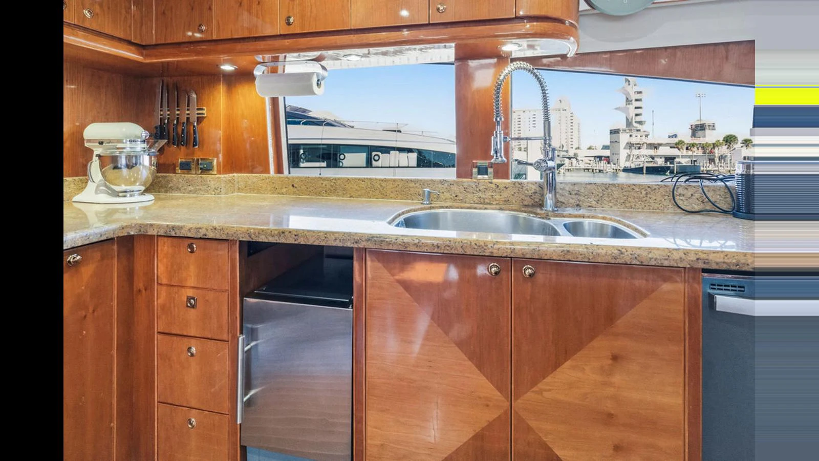 The yacht's galley features polished wood cabinetry, a granite countertop, and modern appliances. aboard PERFECT HARMONY Yacht for Sale