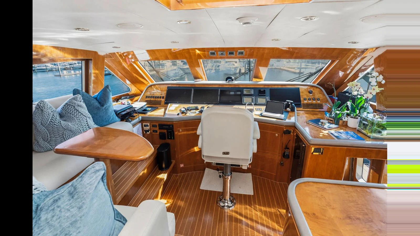 The helm features a sophisticated control area with luxurious seating and expansive windows offering panoramic views. aboard PERFECT HARMONY Yacht for Sale