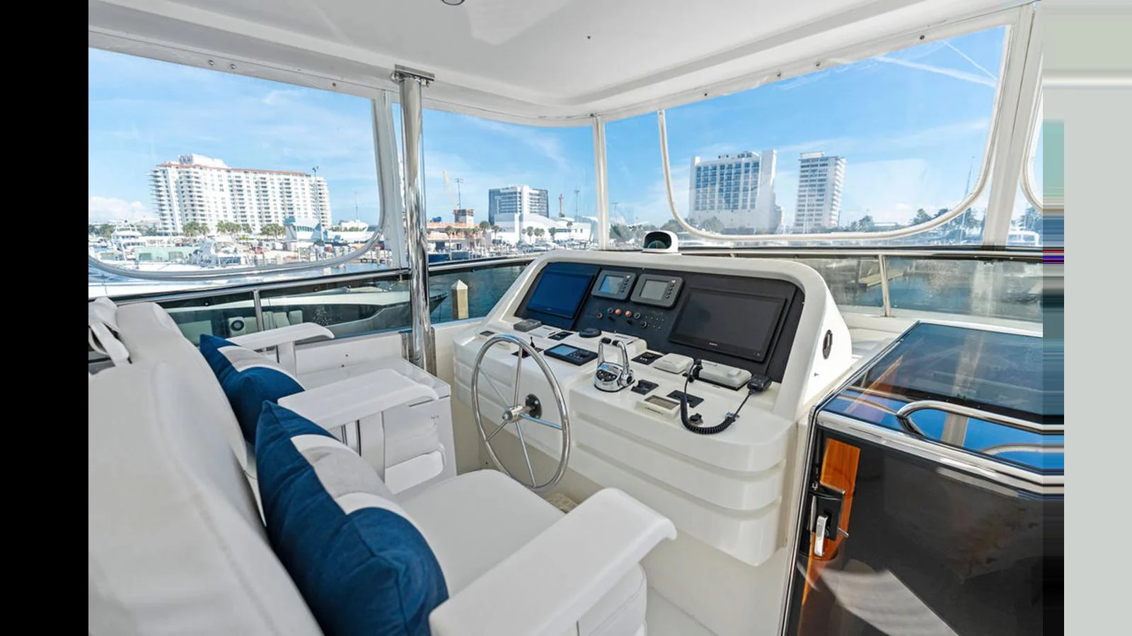The helm station offers a commanding view with modern navigation equipment and comfortable seating. aboard PERFECT HARMONY Yacht for Sale