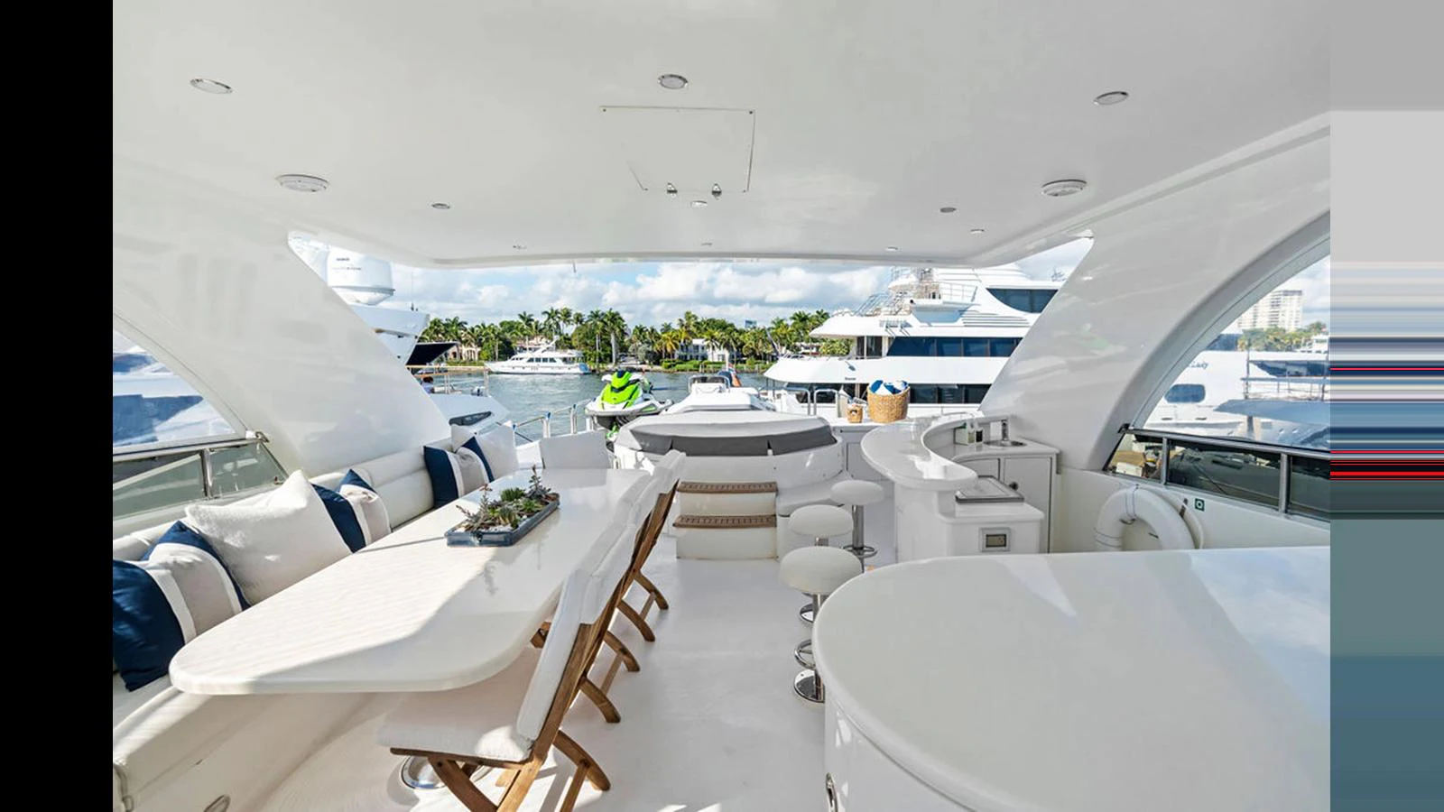 The flybridge offers a spacious and luxurious area for dining and relaxation with stunning views of the marina. aboard PERFECT HARMONY Yacht for Sale