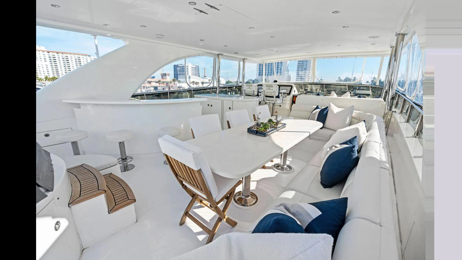 The spacious flybridge offers ample seating and a dining area with a stunning view. aboard PERFECT HARMONY Yacht for Sale
