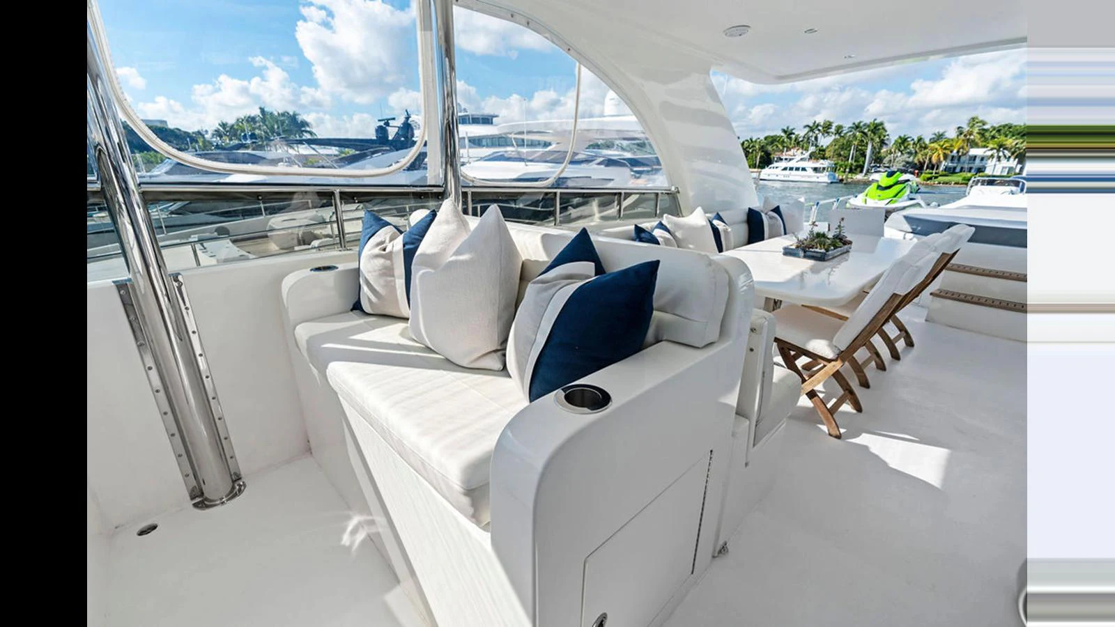 The aft deck features a comfortable seating area with plush cushions and a dining table for al fresco meals. aboard PERFECT HARMONY Yacht for Sale