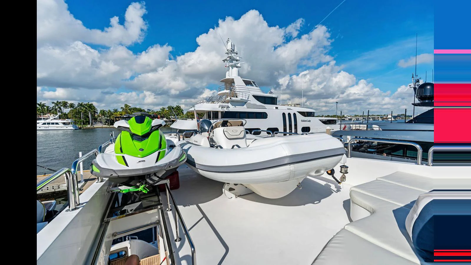 The yacht's deck features a jet ski and a tender, ready for water adventures. aboard PERFECT HARMONY Yacht for Sale