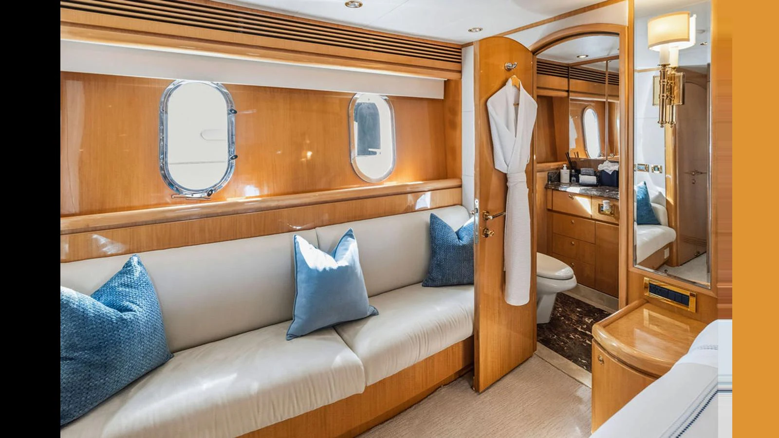 The stateroom features a comfortable seating area with plush cushions and a well-lit vanity space. aboard PERFECT HARMONY Yacht for Sale