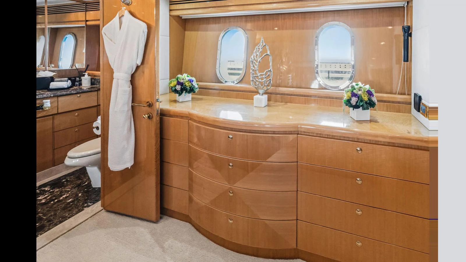 The stateroom features elegant wooden cabinetry, porthole windows, and tasteful decor. aboard PERFECT HARMONY Yacht for Sale