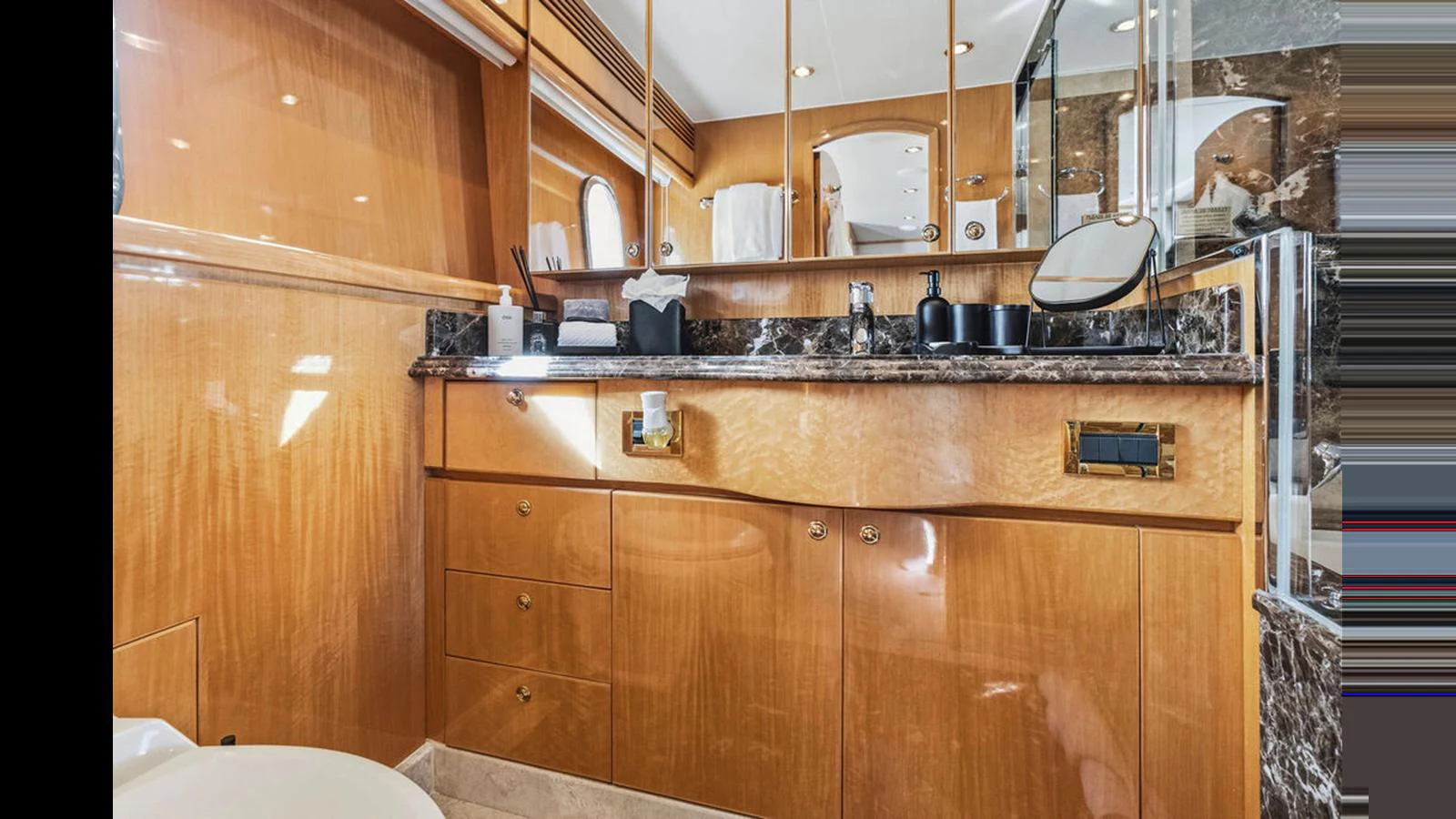 The yacht's bathroom features elegant wood cabinetry and a marble countertop, creating a luxurious and sophisticated atmosphere. aboard PERFECT HARMONY Yacht for Sale