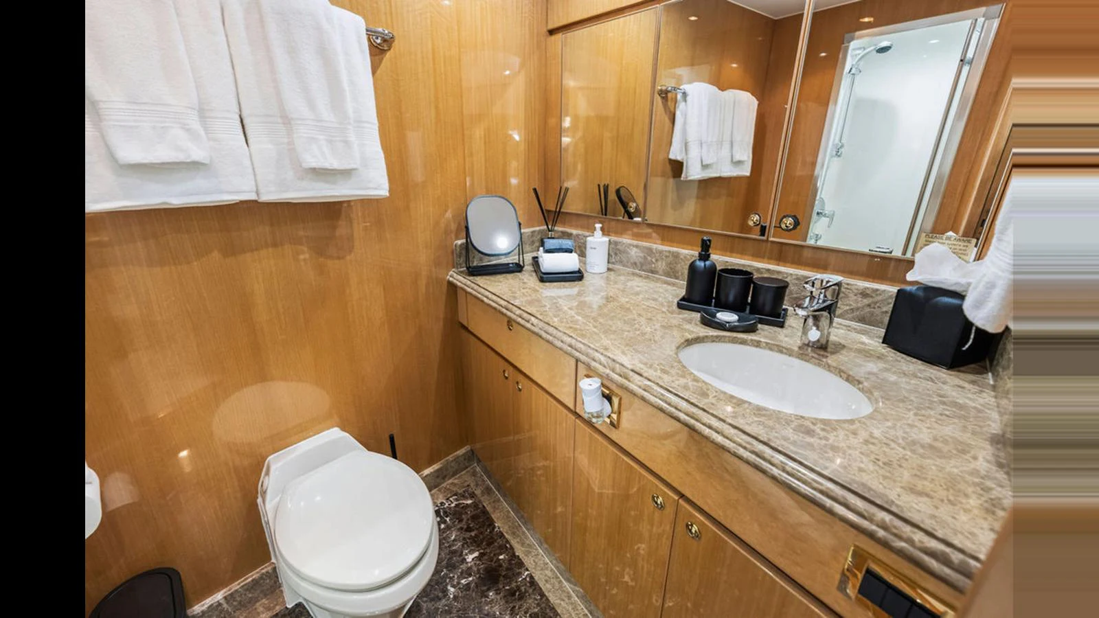 The yacht's bathroom features a luxurious marble countertop and elegant fixtures. aboard PERFECT HARMONY Yacht for Sale