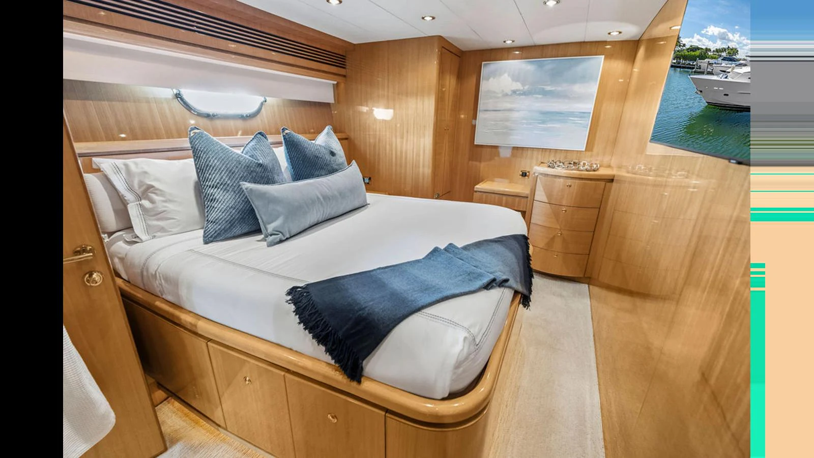 A cozy stateroom featuring a comfortable bed with plush pillows and a soft throw blanket. aboard PERFECT HARMONY Yacht for Sale