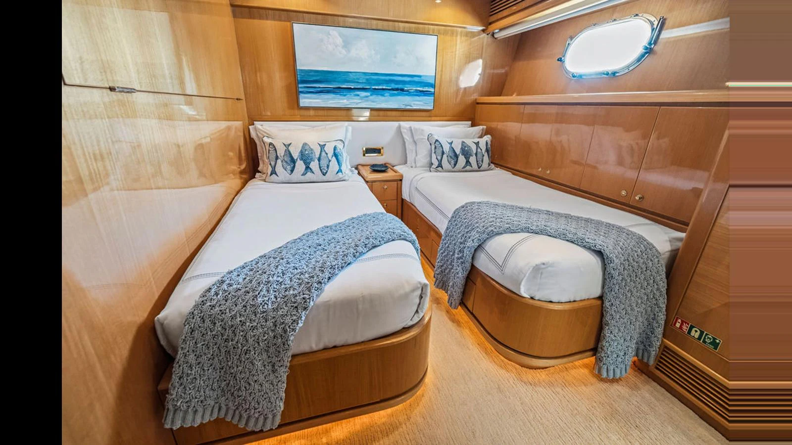 The twin stateroom features two comfortable beds with elegant bedding and a serene ocean-themed painting. aboard PERFECT HARMONY Yacht for Sale