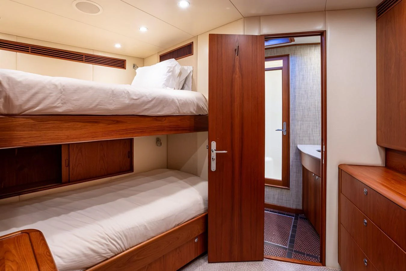 The guest stateroom features cozy bunk beds and a private en-suite bathroom. aboard HT HOOK Yacht for Sale