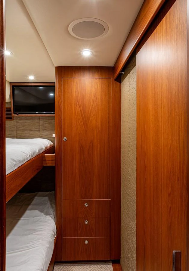A cozy cabin featuring wooden cabinetry and bunk beds. aboard HT HOOK Yacht for Sale