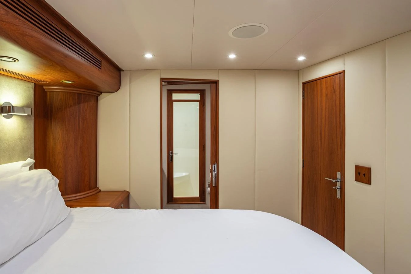 A cozy stateroom featuring a comfortable bed and elegant wooden finishes. aboard HT HOOK Yacht for Sale