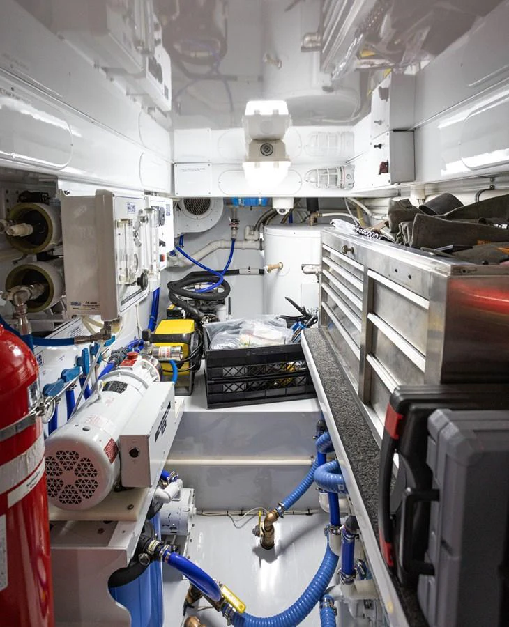 The image showcases a well-organized engine room with various mechanical and electrical components. aboard HT HOOK Yacht for Sale