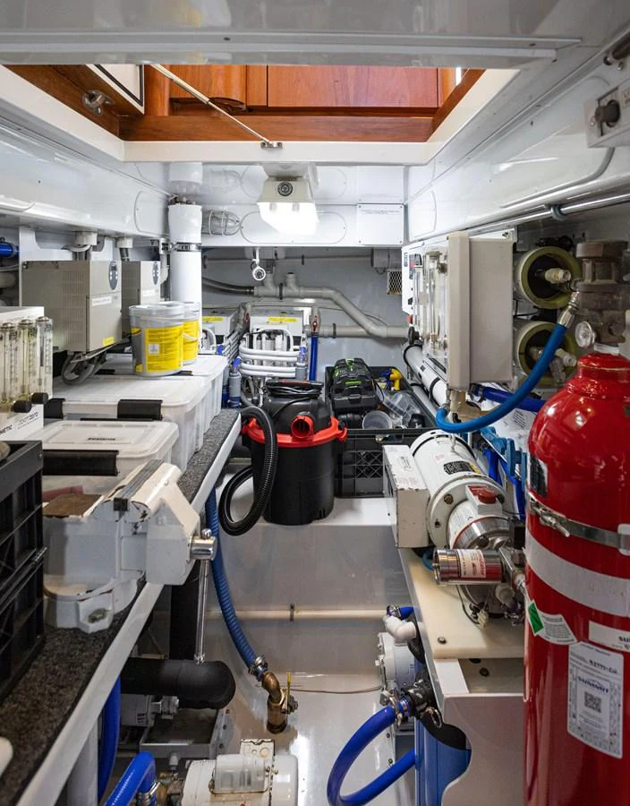 The image showcases the well-organized engine room with various technical equipment and safety features. aboard HT HOOK Yacht for Sale