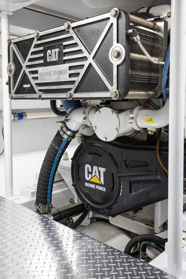 The image showcases the powerful engine room of the yacht, featuring CAT Marine Power equipment. aboard HT HOOK Yacht for Sale