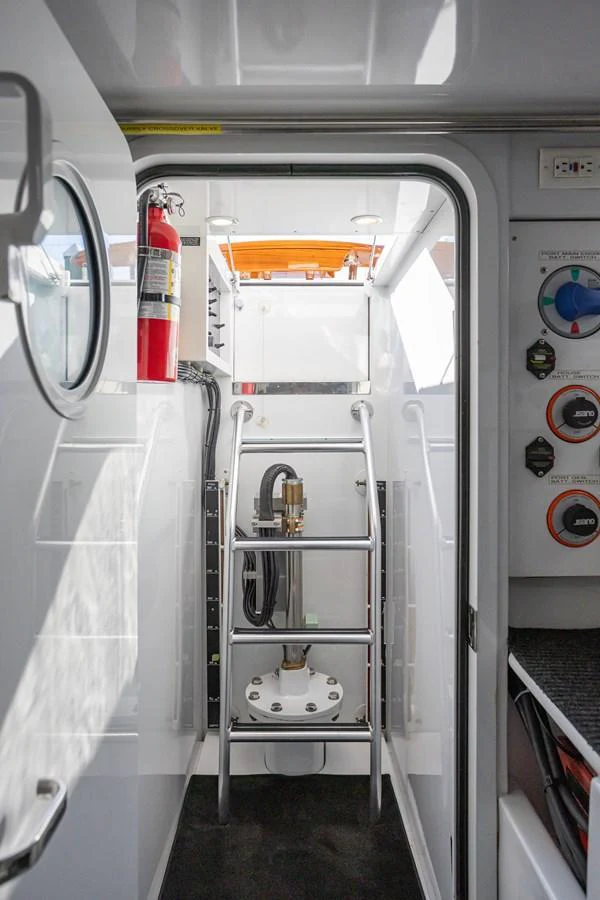 A functional interior space featuring a ladder and essential equipment. aboard HT HOOK Yacht for Sale