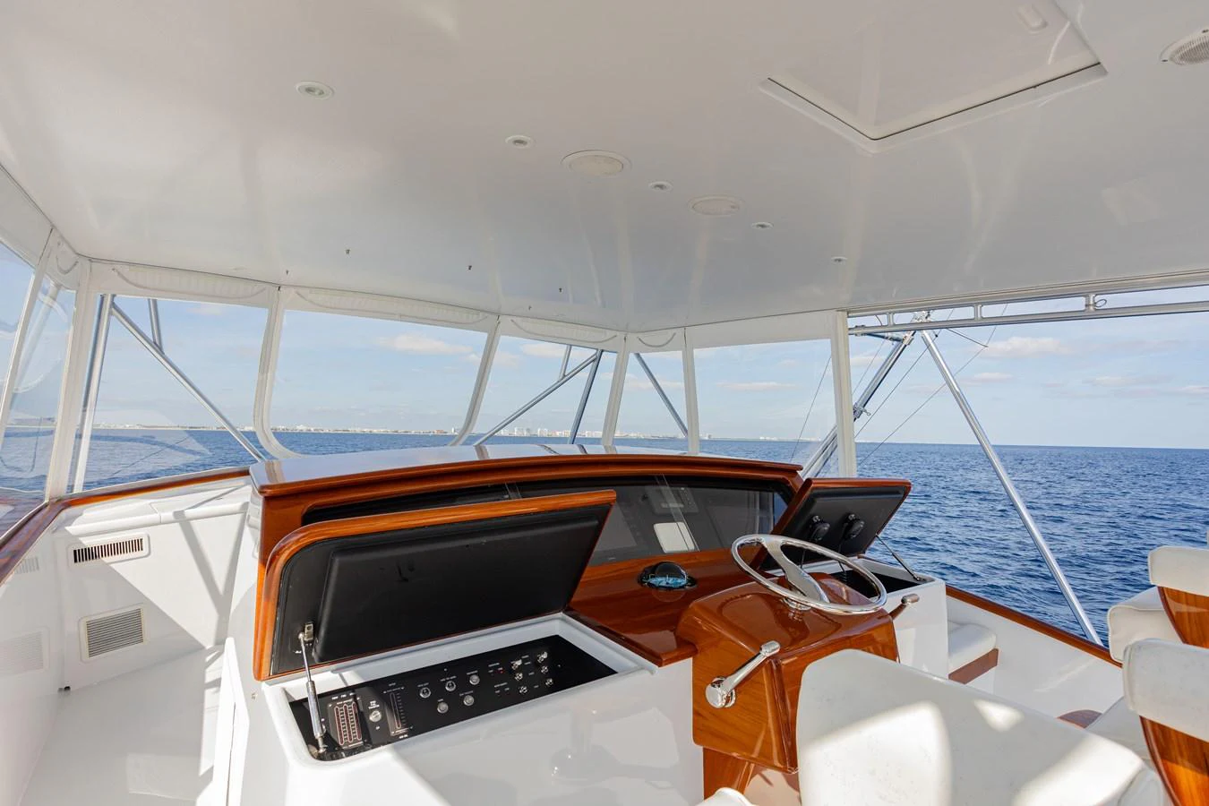 The helm station offers a commanding view of the open sea, featuring modern navigation equipment and luxurious finishes. aboard HT HOOK Yacht for Sale