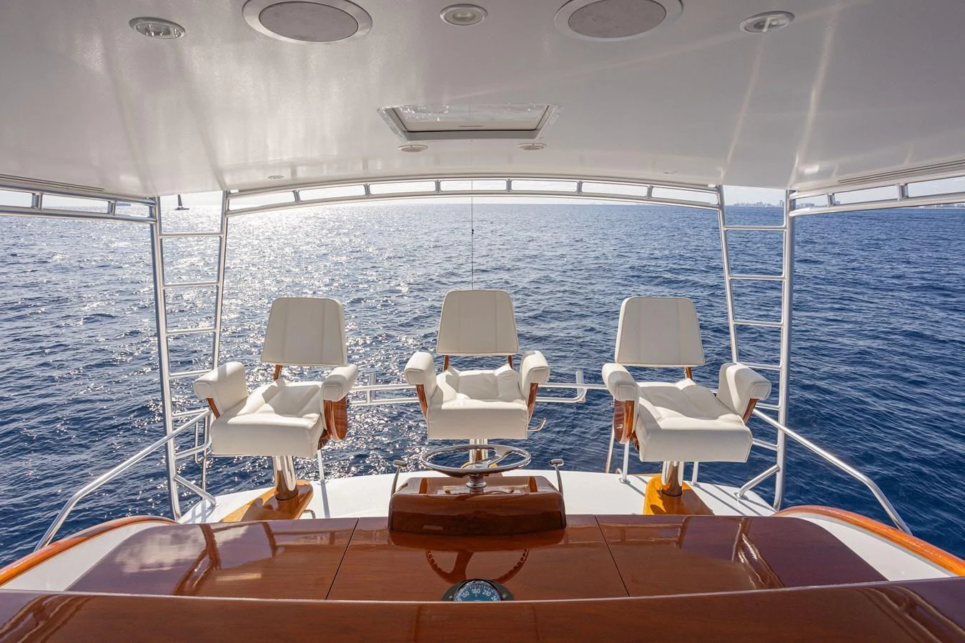 The flybridge offers a stunning view of the open sea with comfortable seating for three. aboard HT HOOK Yacht for Sale