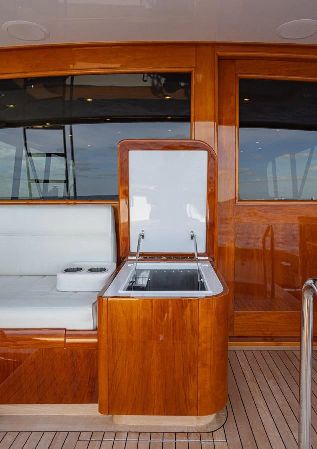 A luxurious aft deck detail featuring a built-in cooler and seating area. aboard HT HOOK Yacht for Sale