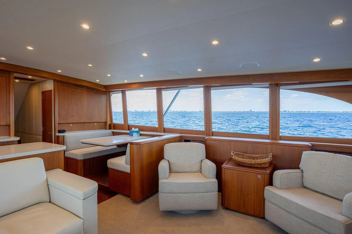 The salon offers a spacious and comfortable seating area with large windows providing stunning ocean views. aboard HT HOOK Yacht for Sale