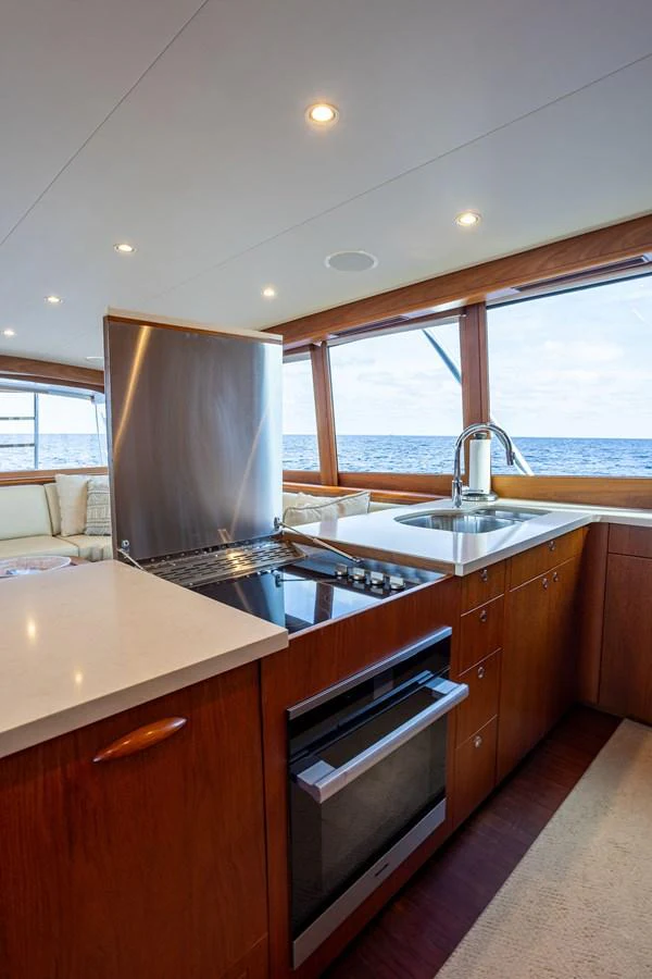 A modern galley with stainless steel appliances and ocean views. aboard HT HOOK Yacht for Sale
