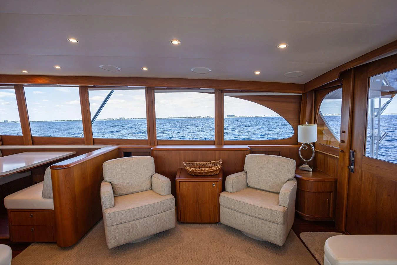 The salon features comfortable seating with large windows offering stunning ocean views. aboard HT HOOK Yacht for Sale