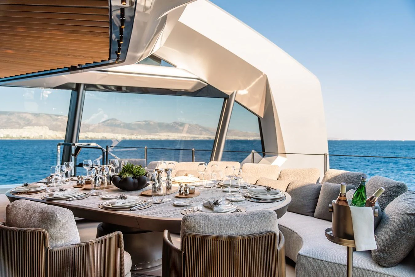 a table with a glass and a view of the ocean aboard THIS IS IT I Yacht for Sale