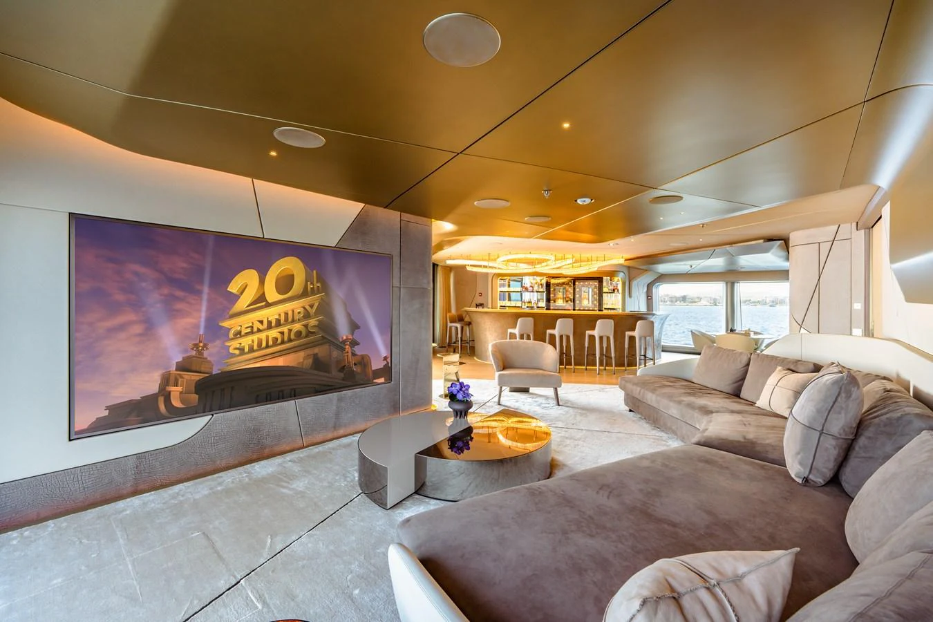 a living room with a large screen aboard THIS IS IT I Yacht for Sale